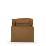 Copper TUMI pouch with gold zipper and 'TUMI' branding on a white background