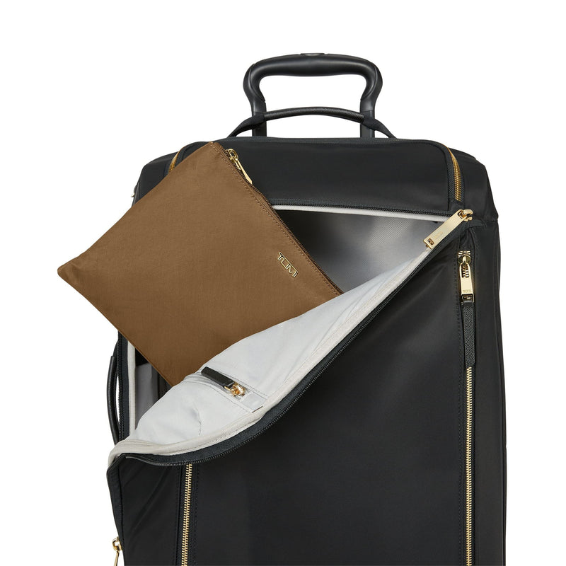 Black TUMI suitcase with a copper pouch and gold zipper on a white background
