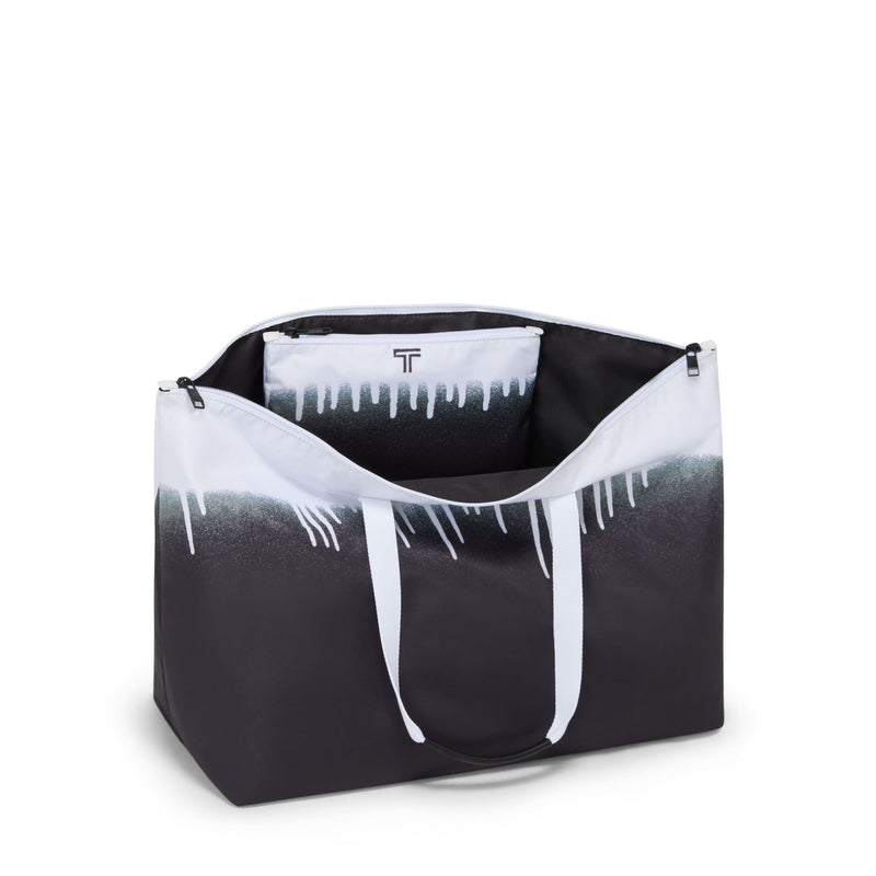 Black and white TUMI bag with a brand logo on a white background