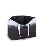 Black and white TUMI tote bag with gradient design on a white background