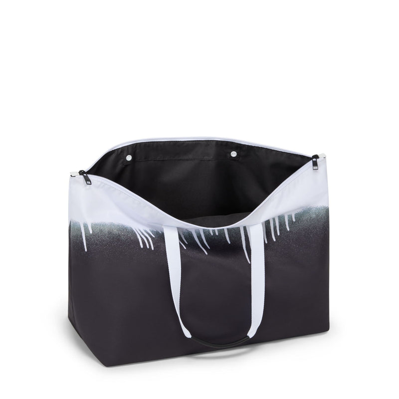 Black and white TUMI tote bag with gradient design on a white background