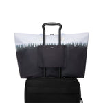 Black TUMI tote bag with a gradient design on a white background