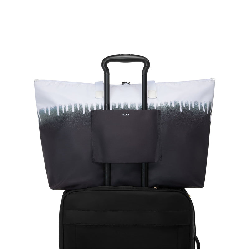 Black TUMI tote bag with a gradient design on a white background