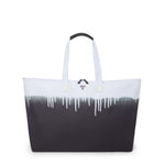 Black and white TUMI tote bag with a gradient design on a white background