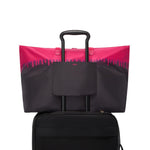 Black and pink TUMI tote bag on a white background