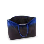 Black TUMI tote bag with blue handles on a white background