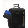 Black TUMI suitcase with gold accents and a blue pouch on a white background