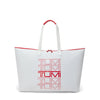 White TUMI tote bag with red accents and 'TUMI' branding on a white background