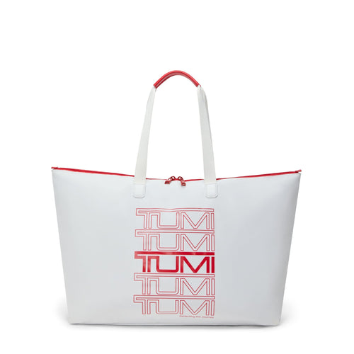 White TUMI tote bag with red accents and 'TUMI' branding on a white background