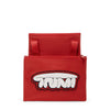 Red TUMI pouch with a white and black logo on a white background