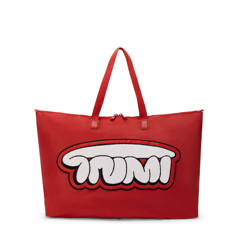 Red TUMI tote bag with a white graphic design on a white background