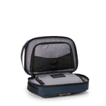Open TUMI travel toiletry bag on a white background