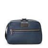 Blue TUMI toiletry bag with a visible brand logo on a white background