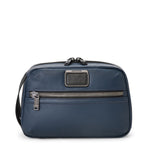 Blue TUMI toiletry bag with a visible brand logo on a white background