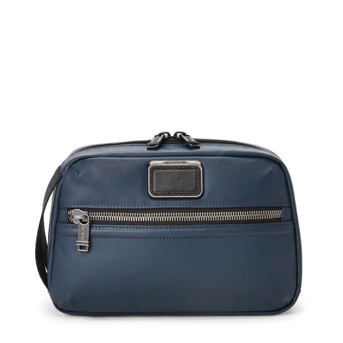 Blue TUMI toiletry bag with a visible brand logo on a white background