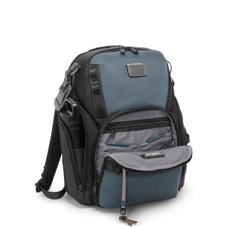 Blue and black TUMI backpack on a white background