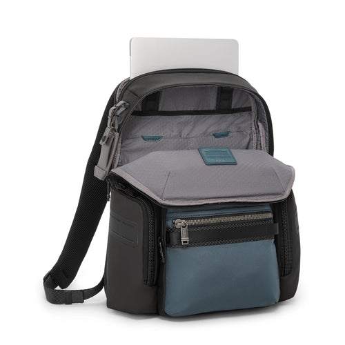 TUMI backpack with compartments and a laptop on a white background