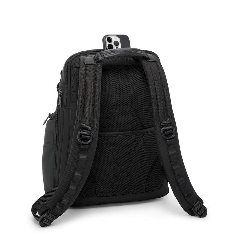 Black TUMI backpack with multiple compartments on a white background