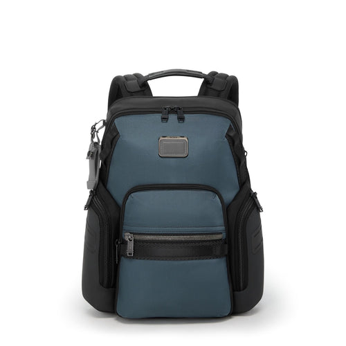 Blue and black TUMI backpack on a white background