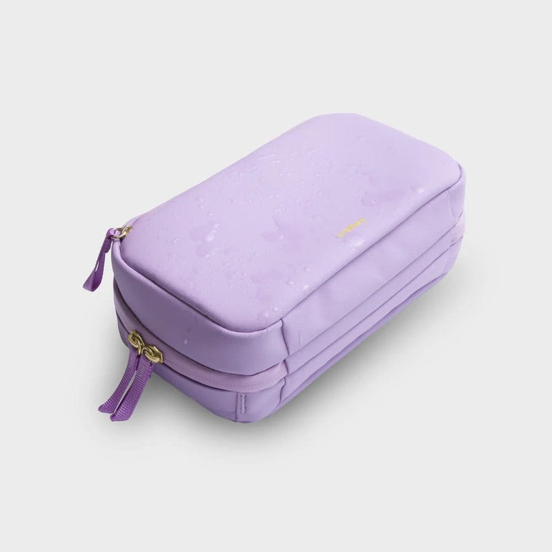 Purple orbitkey travel case with gold zipper on a light gray background