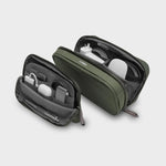 Green orbitkey travel case with organized compartments on a light gray background