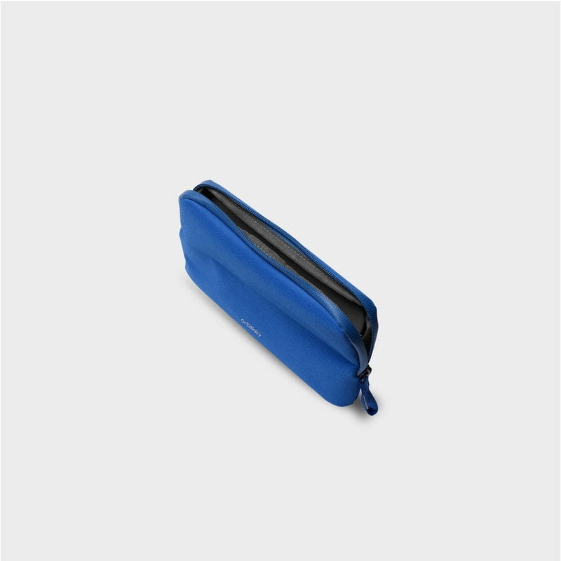Blue orbitkey pouch with a zipper on a light gray background