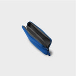 Blue orbitkey pouch with a zipper on a light gray background