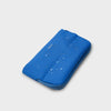Blue orbitkey phone case with water droplets on a light gray background