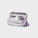 Purple and white orbitkey travel organizer with electronic devices on a light gray background