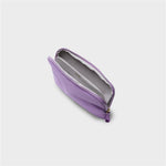 Purple orbitkey pouch with a gold zipper on a light gray background