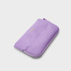 Purple orbitkey phone case with water droplets on a light gray background