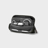 Olive orbitkey travel organizer with various items on a light gray background