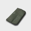 Green orbitkey phone case with water droplets on a light gray background