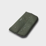 Green orbitkey phone case with water droplets on a light gray background