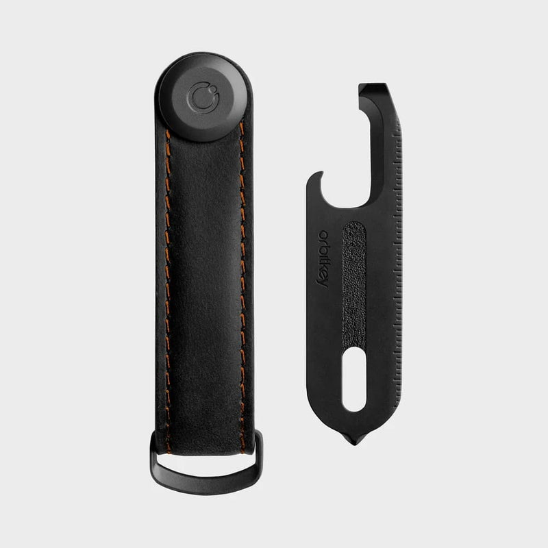 orbitkey black leather key organizer with a clip on a light gray background