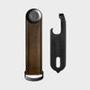 orbitkey brown leather key organizer with black clip on a light gray background