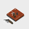 orbitkey key organizer with leather strap on a brown box against a white background