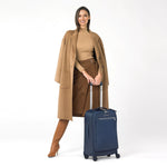 model with navy Briggs & Riley Rhapsody Tall Carry-On Spinner