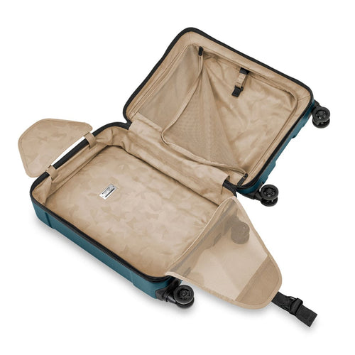 Open Briggs & Riley suitcase with blue exterior and beige interior on a white background