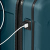 Ocean Briggs & Riley suitcase with a USB cable plugged into a charging port