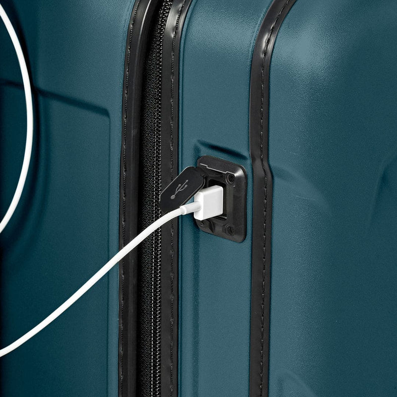 Ocean Briggs & Riley suitcase with a USB cable plugged into a charging port
