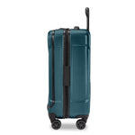 Ocean Briggs & Riley suitcase with a black handle and wheels on a white background