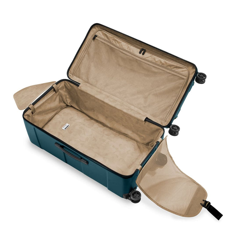 Open Briggs & Riley suitcase with beige interior on a white background