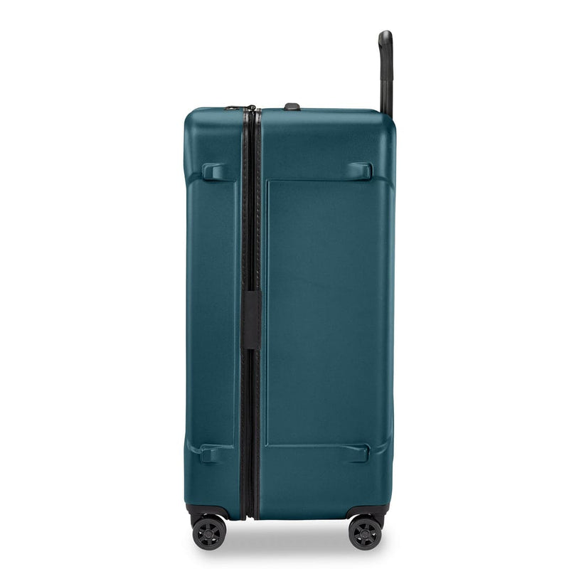 Ocean Briggs & Riley suitcase with a black handle and wheels on a white background