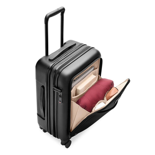 Black Briggs & Riley suitcase with open compartment showing red and beige items on a white background