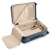 Open navy Briggs & Riley suitcase with beige interior on a white background