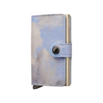 Cloud-patterned Secrid wallet with a metallic button on a white background
