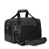 Black Briggs & Riley travel bag with shoulder strap on a white background