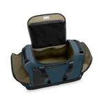 Open blue Briggs & Riley duffel bag on a white background