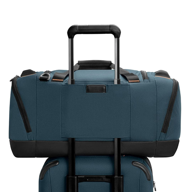 Blue Briggs & Riley duffel bag with black accents on a white background